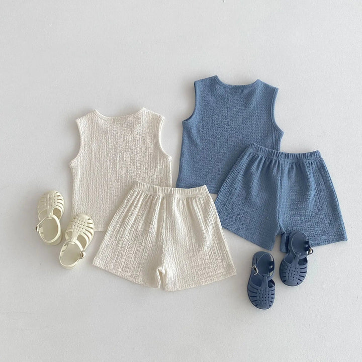 Beige and blue matching sets with sleeveless tops and gathered-waist shorts.