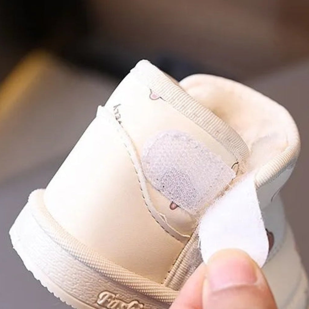 Close-up of a beige boot with its hook-and-loop strap open