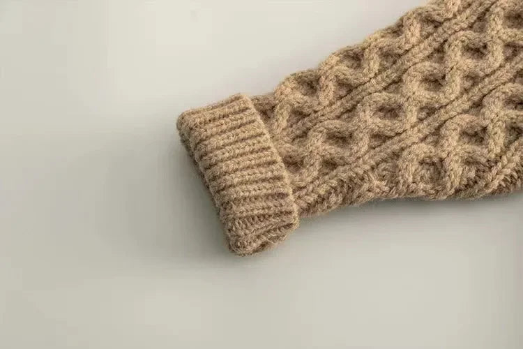 Beige cardigan sleeve with raised cable knitting and a ribbed cuff