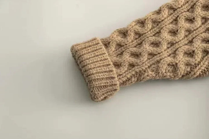 Beige cardigan sleeve with raised cable knitting and a ribbed cuff