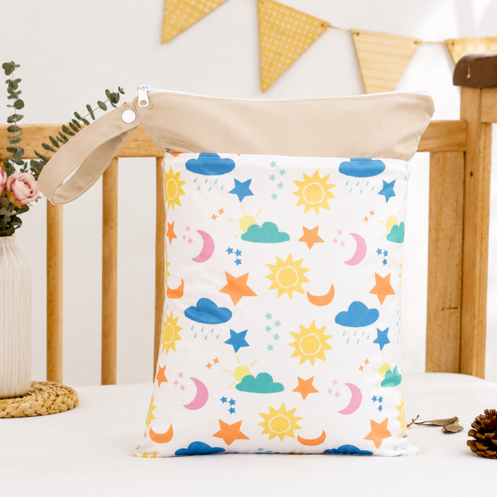 Beige-trim diaper wet bag with suns, moons, stars, and clouds