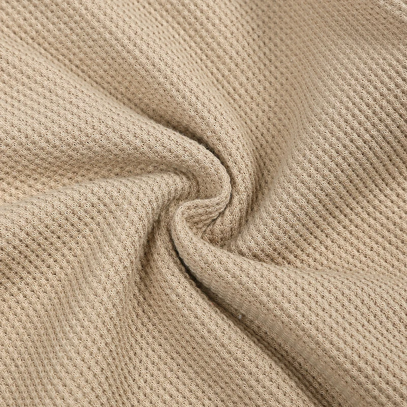 Close-up of the beige cotton-blend knit fabric texture