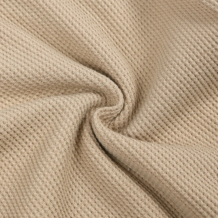 Close-up of the beige cotton-blend knit fabric texture
