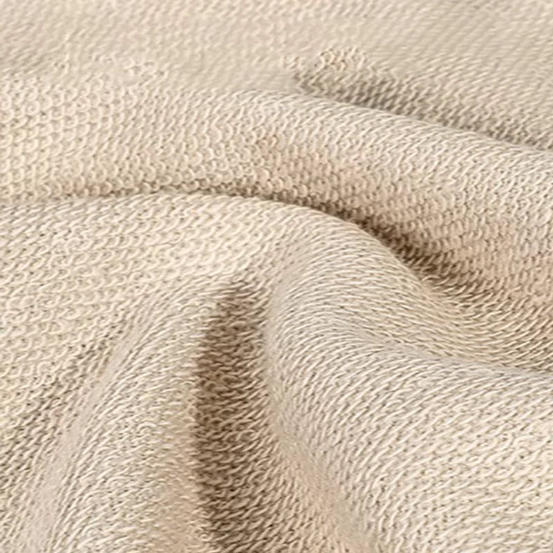 Close-up of the looped inner fabric of a beige cotton Christmas sweater