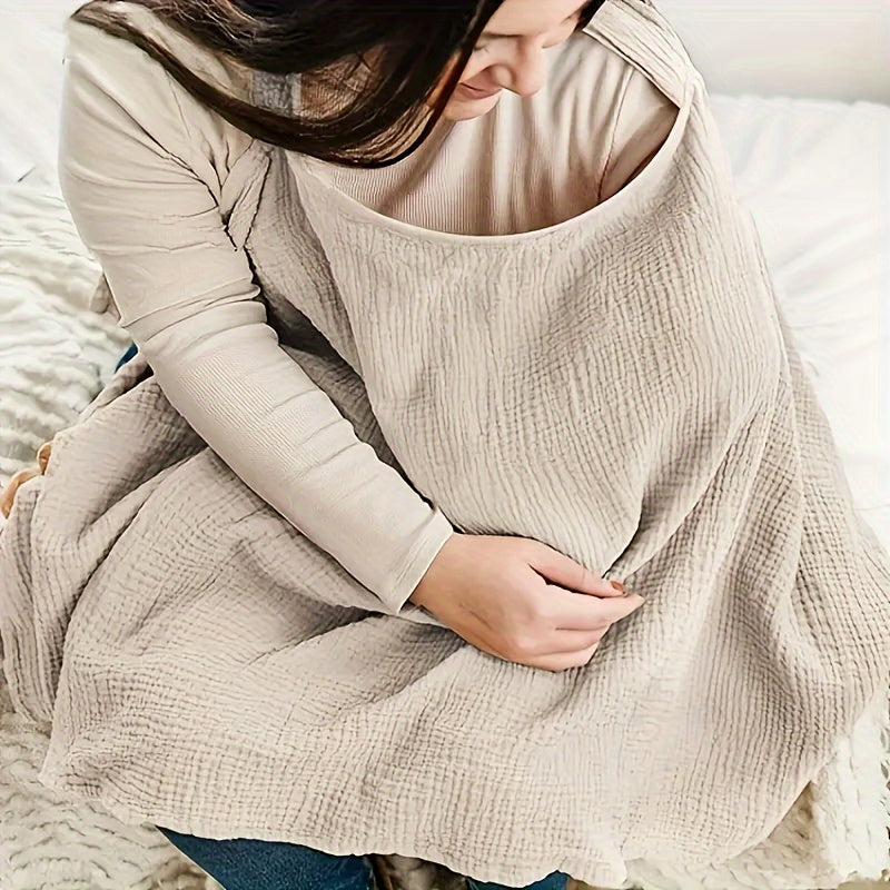 Beige cotton nursing scarf covering a seated mother&