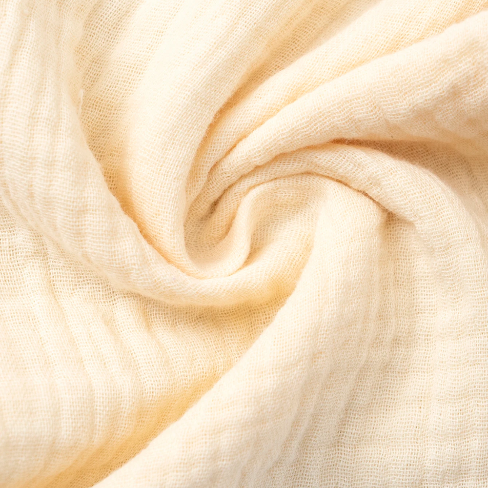 Beige cotton fabric gathered to show its crinkled texture