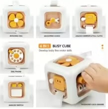 Beige activity cube with a flower spinner, key, rotary dial, switches, and pull-cord panel