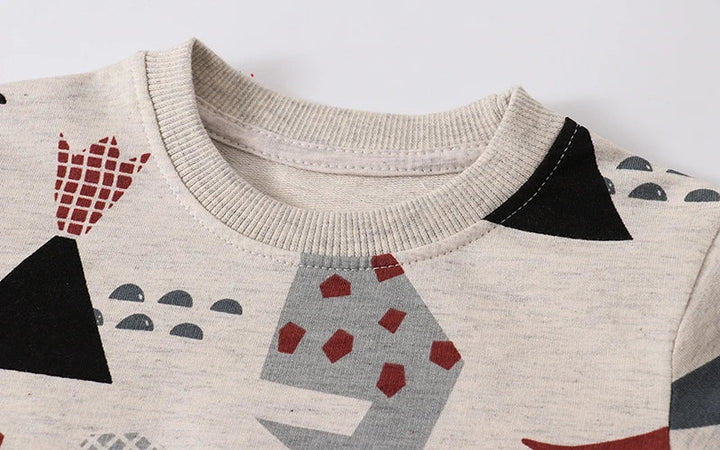Ribbed crewneck detail on a beige dinosaur-print cotton sweatshirt