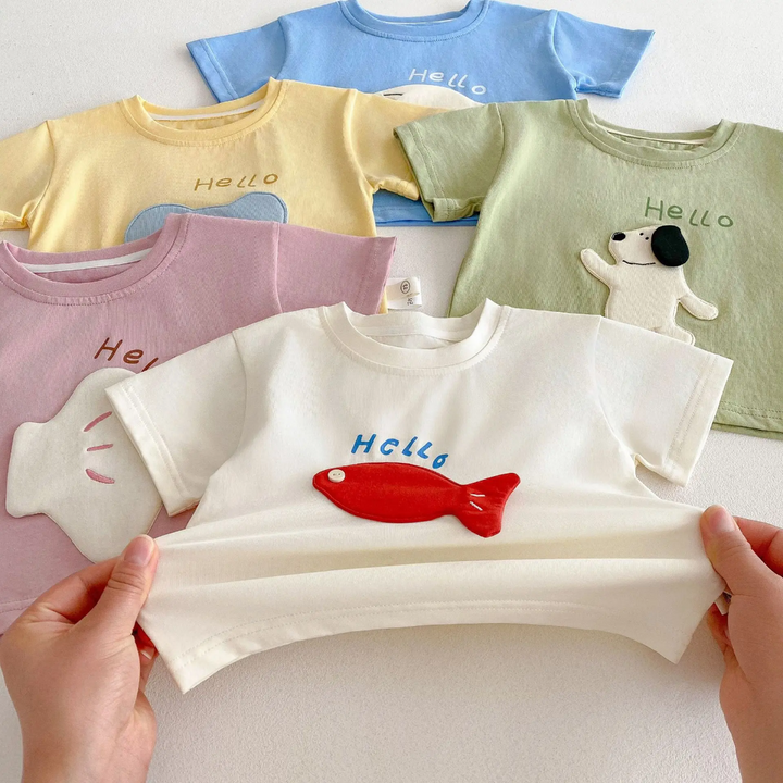 Beige T-shirt with a red fish patch held by its hem in front of four other color options