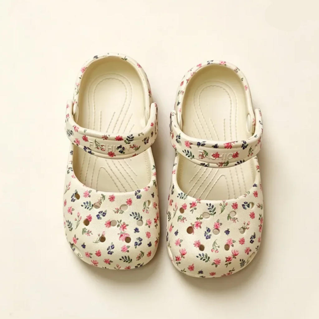 Beige floral Mary Jane sandals viewed from above, showing closed toes and adjustable straps