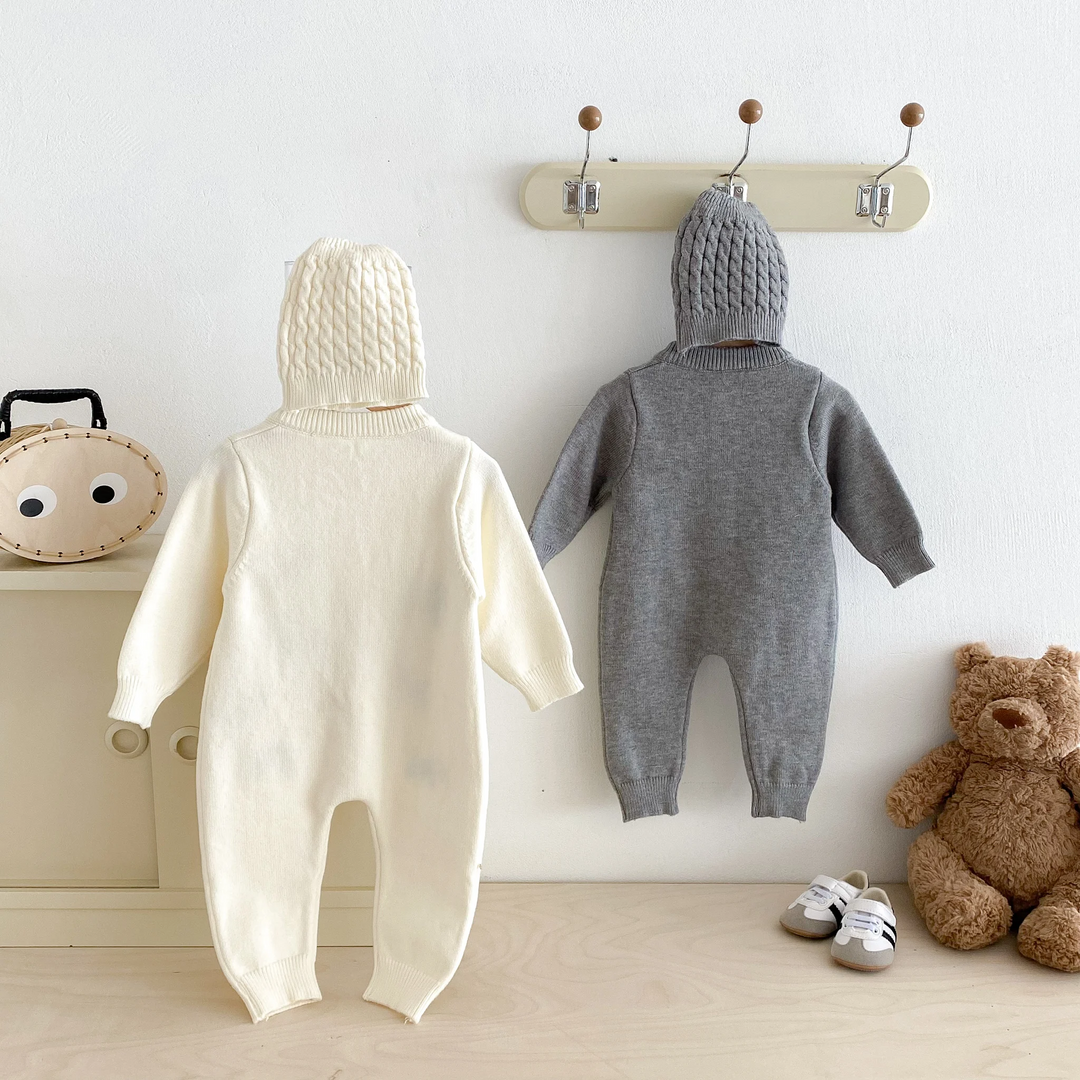 Back view of beige and gray knitted baby jumpsuits with ribbed ankle cuffs