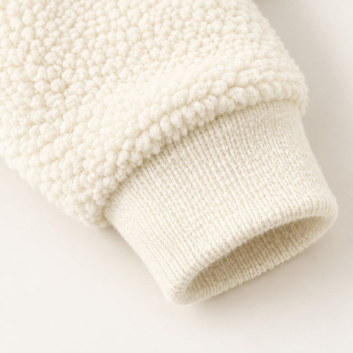 Textured beige jacket sleeve with a ribbed knit cuff