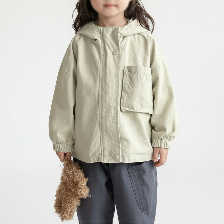 Child wearing a beige parka with a hood, chest pocket, and elastic cuffs
