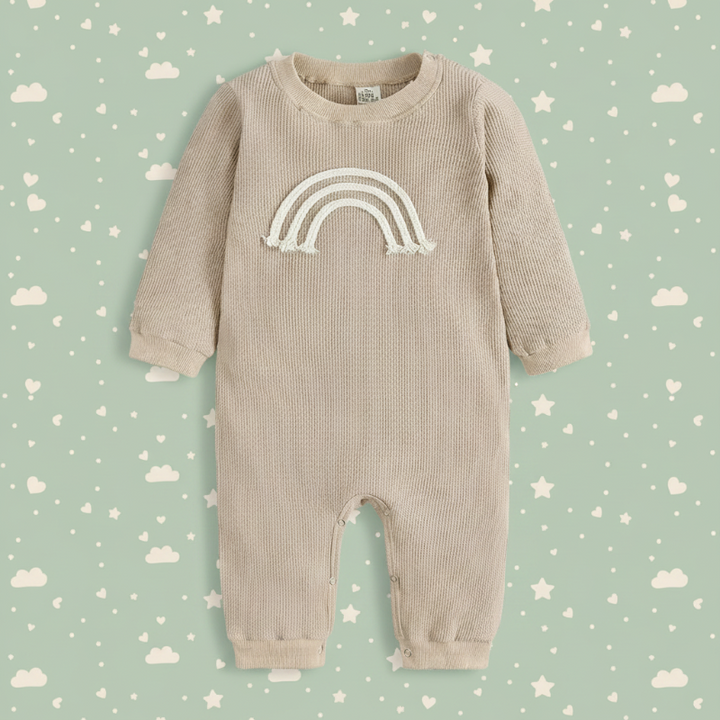 Beige rainbow baby romper with long sleeves, full-length legs, and cuffed ankles