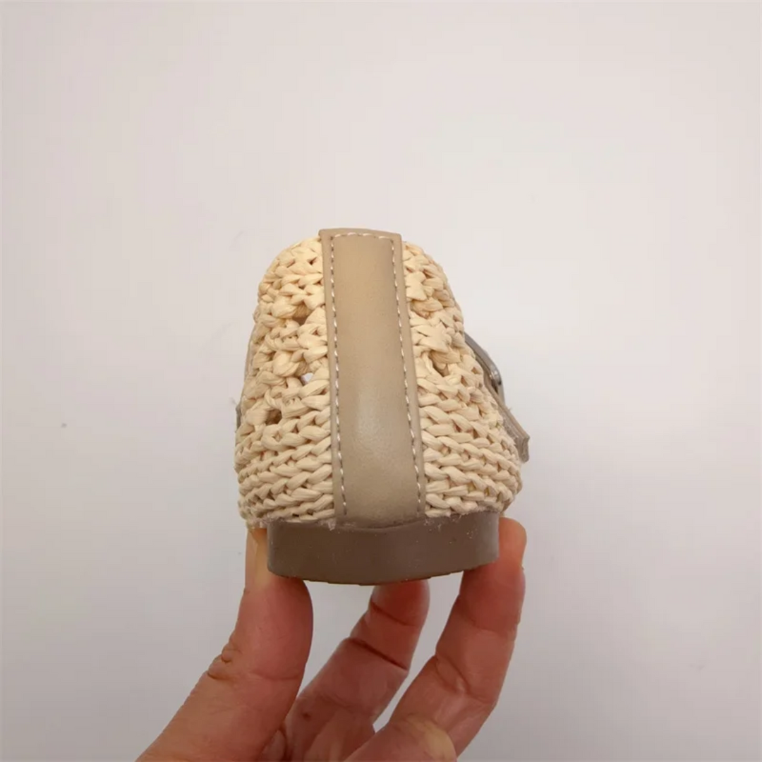 Rear view of a beige Mary Jane flat showing the heel trim and low sole