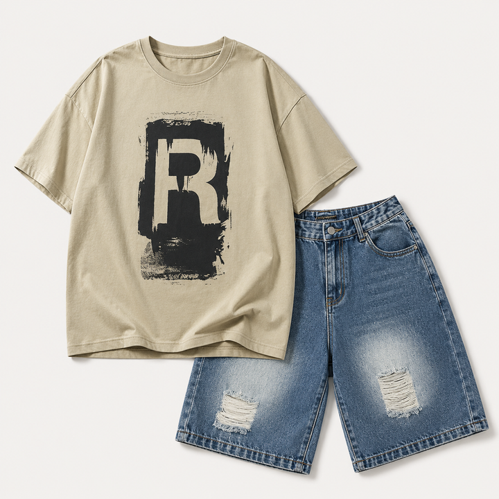 Beige T-shirt with a black R graphic alongside blue distressed denim shorts.