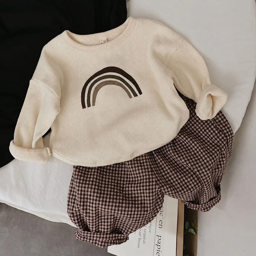 Beige rainbow long sleeve T-shirt styled with brown gingham shorts