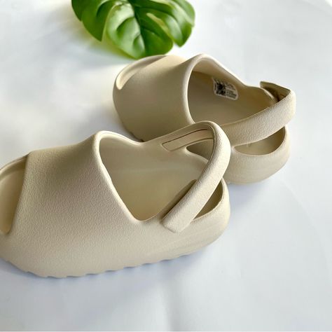 Beige sandals showing textured uppers, open toes, and adjustable heel straps.