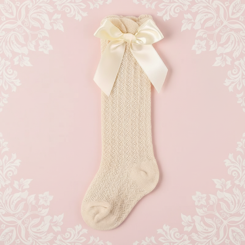 Beige pointelle knee-high sock with a matching satin bow