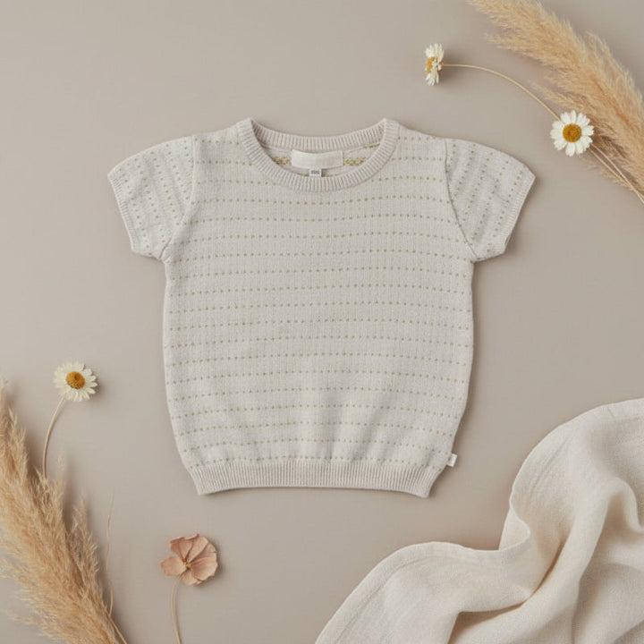 Beige knit pullover top with short sleeves and ribbed edges