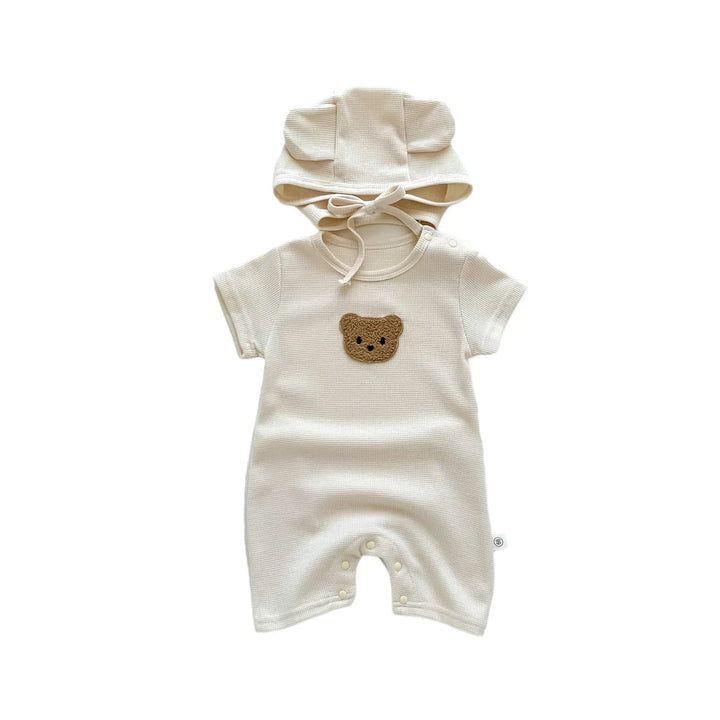 Beige short-sleeve bear romper with matching hat on a white background