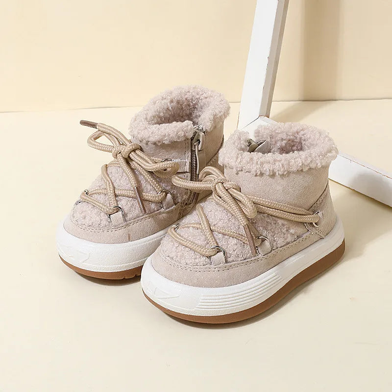 Pair of beige winter boots showing the side zipper and fluffy ankle collars