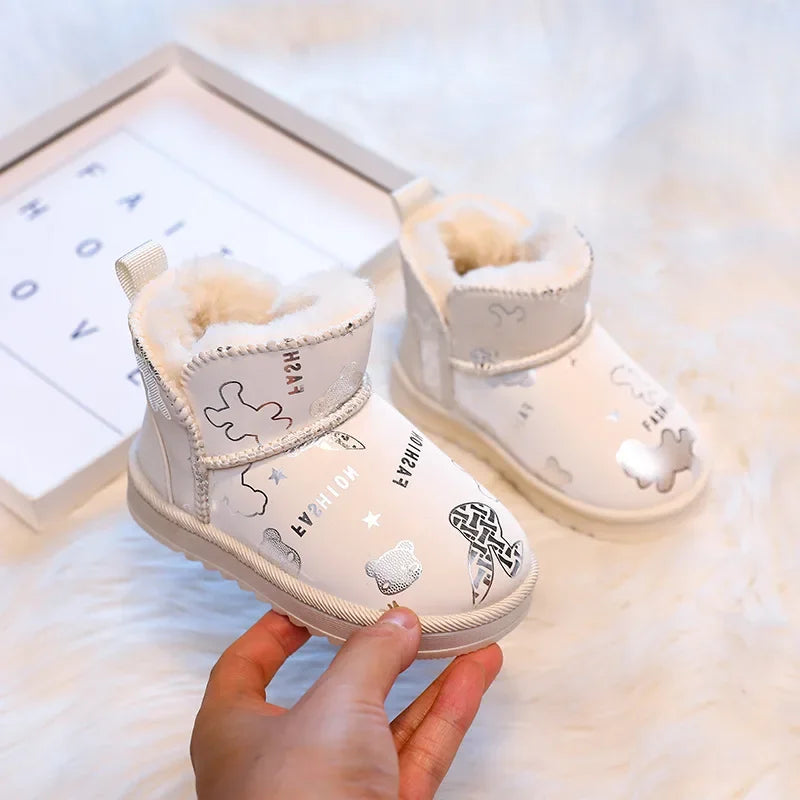 Beige printed snow boots with cream-colored lining and wide front straps