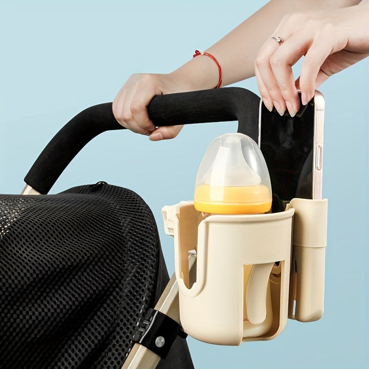 Beige stroller holder carrying a baby bottle and phone beside the handle.