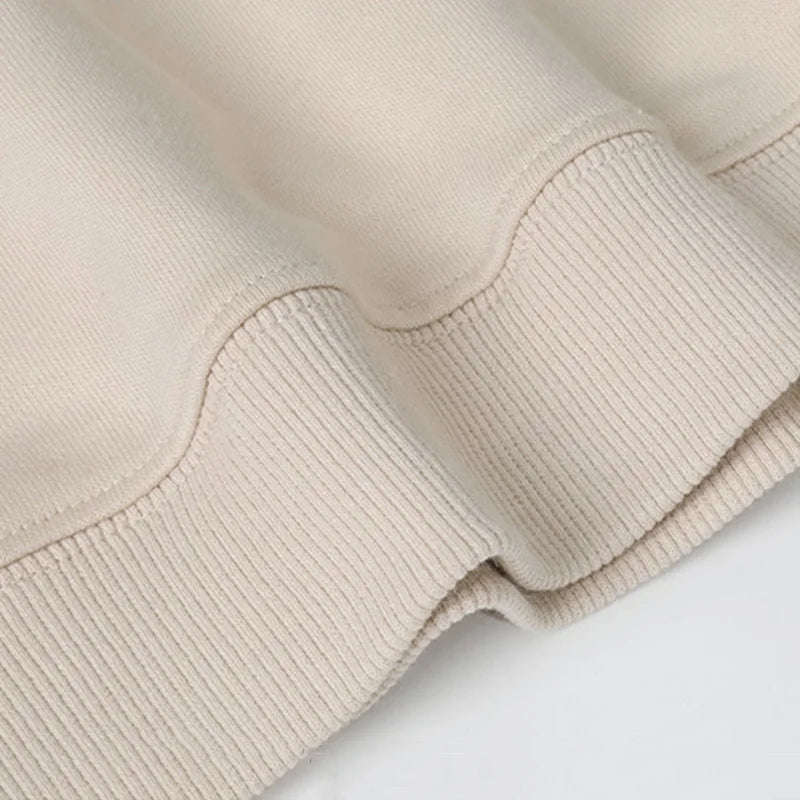 Ribbed cuffs and hem on a beige Christmas sweater
