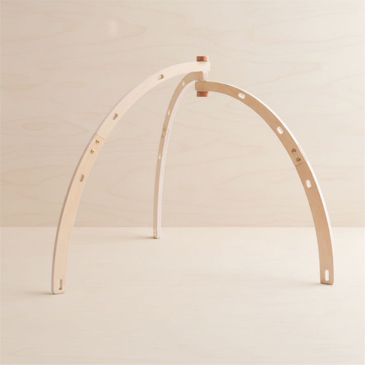 Bentwood baby gym frame with curved natural wood supports.