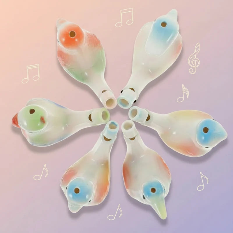Six pastel bird whistles arranged in a circle with mouthpieces pointing inward