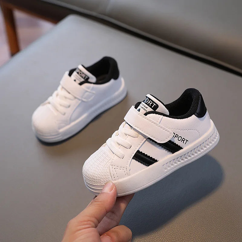 White kids' sneakers with black collars and side stripes, shown as a pair