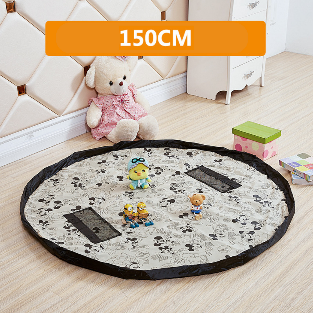 Black-and-white character-print play mat with a black border and mesh pockets.