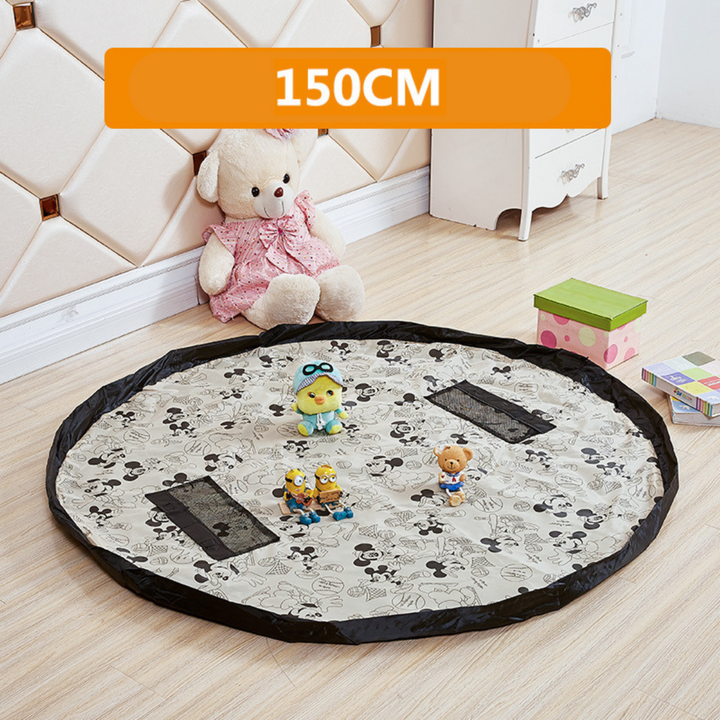 Black-and-white character-print play mat with a black border and mesh pockets.