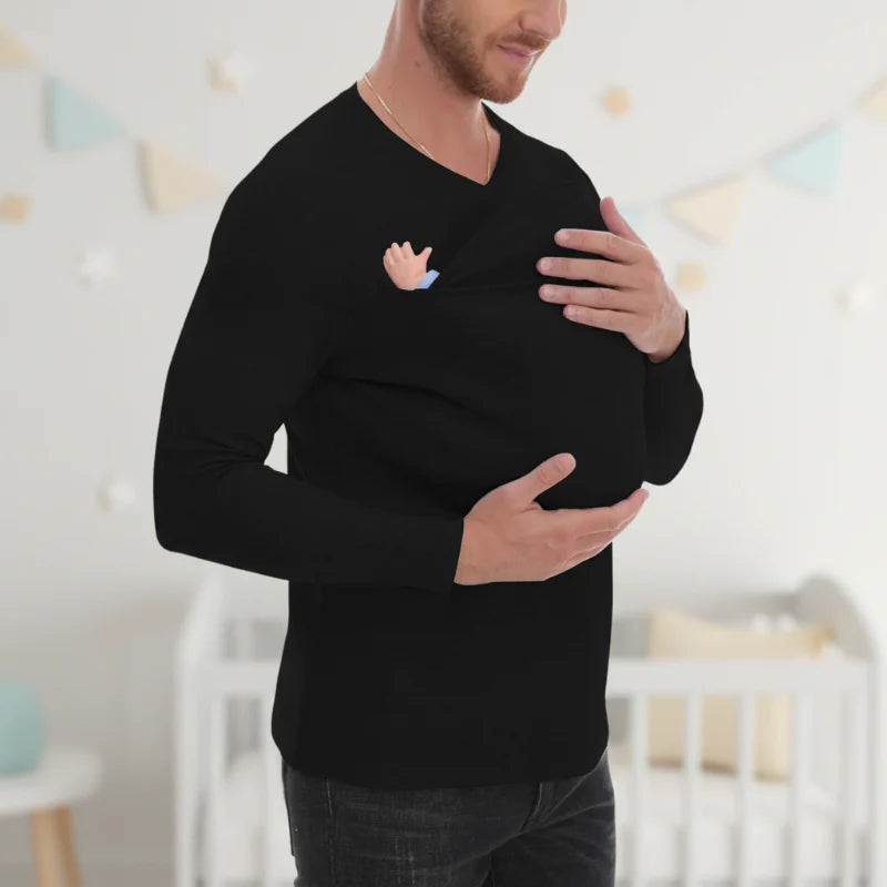 Man wearing a black V-neck baby carrier shirt with a baby in the front pouch.