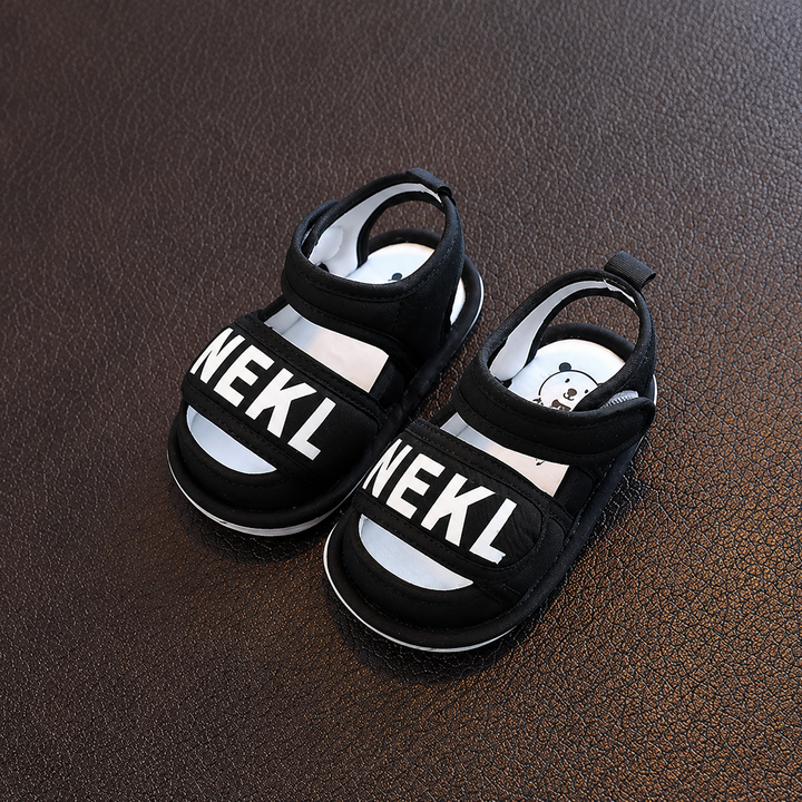 Pair of black baby sandals with wide front straps and adjustable ankle straps