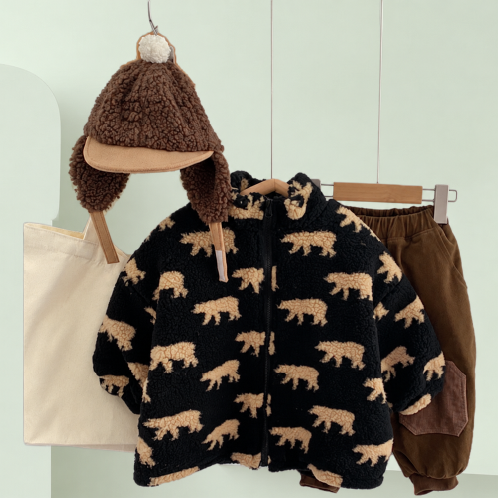 Black bear-print fleece jacket on a hanger beside a brown hat and shorts
