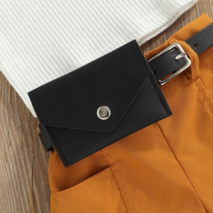 Black waist bag with a silver-tone snap and buckle belt over mustard shorts.