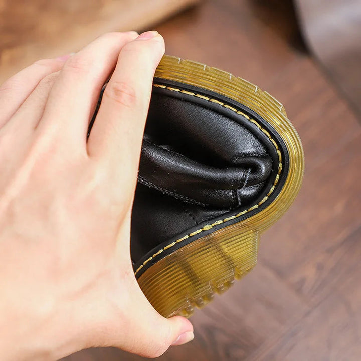 Hand bending a black boot to show its flexible rubber sole