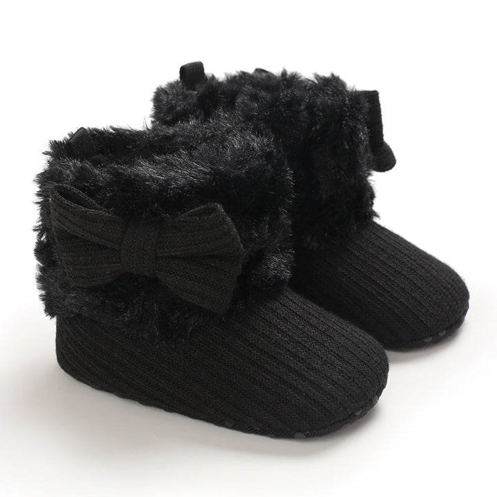 Black baby winter boots with ribbed uppers, plush cuffs, and matching bows