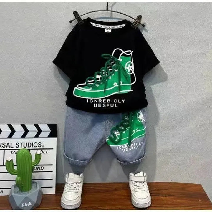 Front view of the black sneaker-print T-shirt and cuffed blue denim shorts displayed on hangers