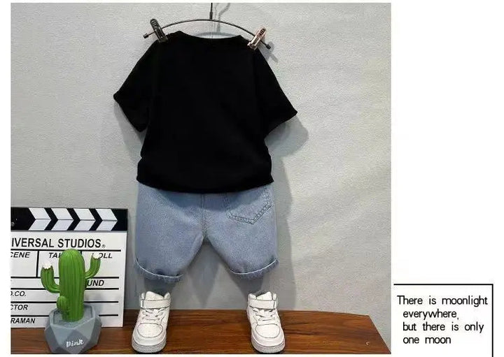Back view of the black T-shirt and blue denim shorts with rear pockets