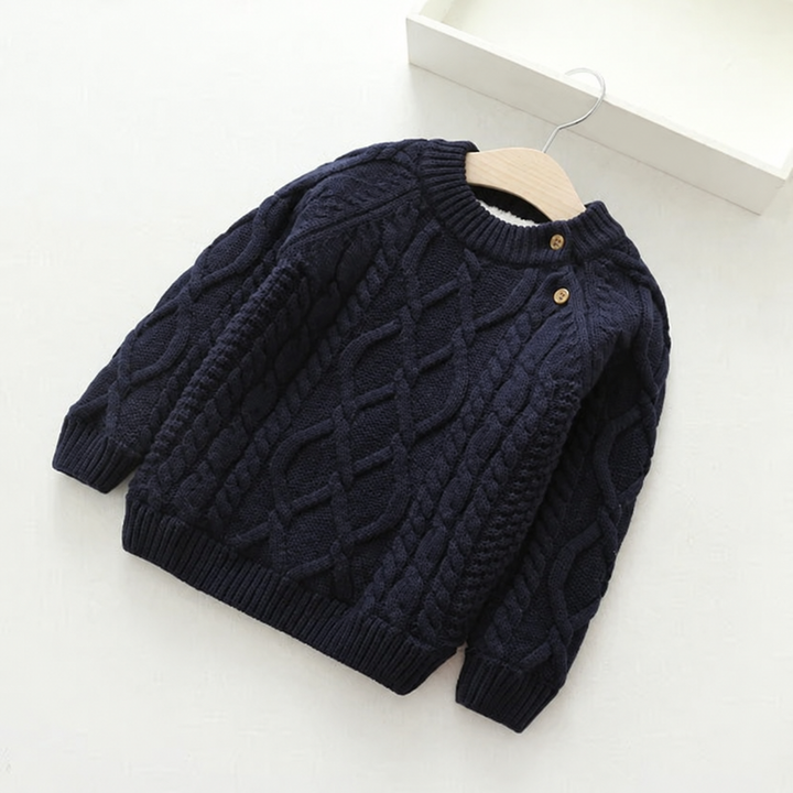 Black cable-knit sweater with a round neck and two contrasting shoulder buttons.