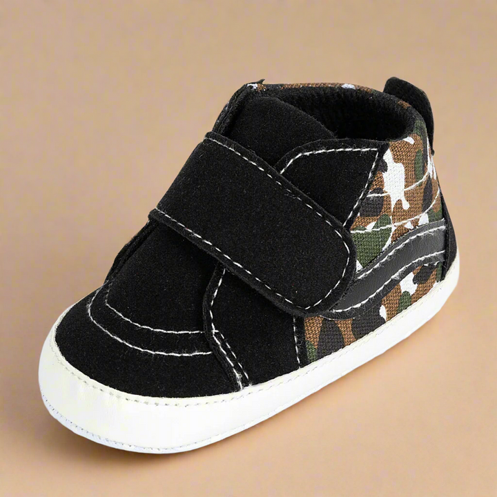 Black baby sneaker with a camouflage panel and a wide hook-and-loop strap