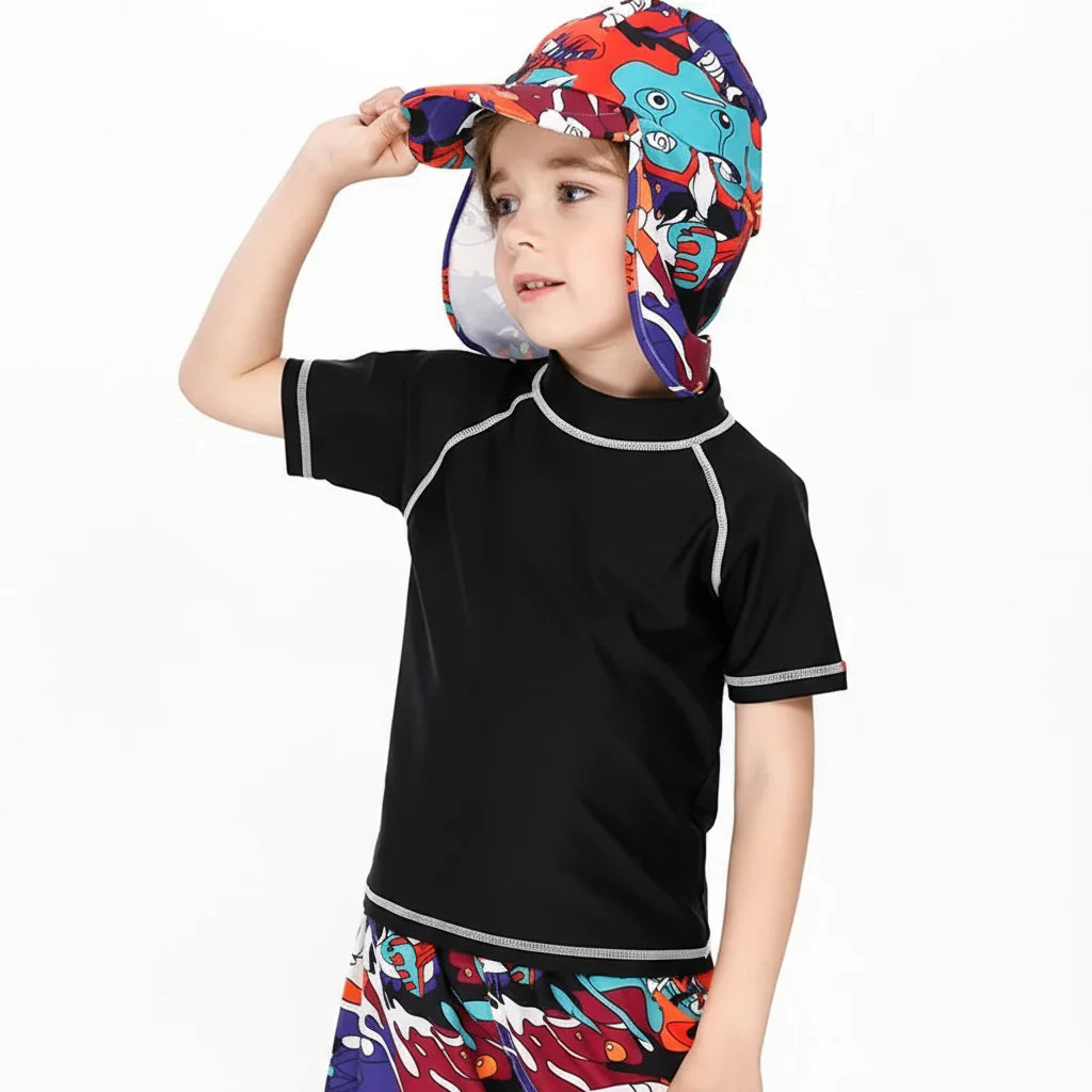 Child wearing a black short-sleeve swim shirt with white contrast seams
