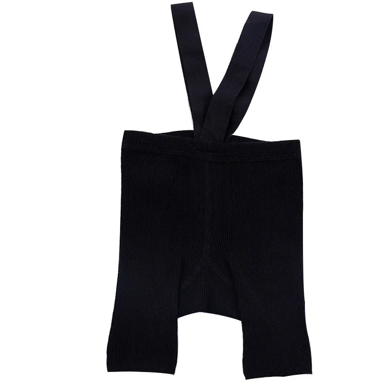 Black ribbed suspender shorts with shoulder straps on a white background.