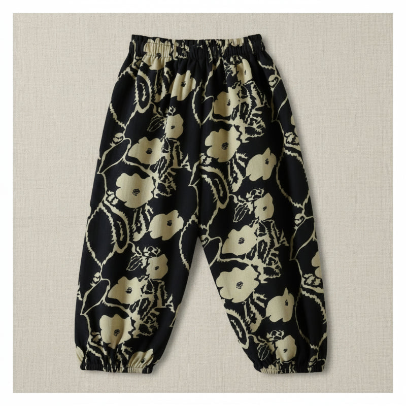 Black harem pants with a cream floral and vine print and elastic ankle cuffs.