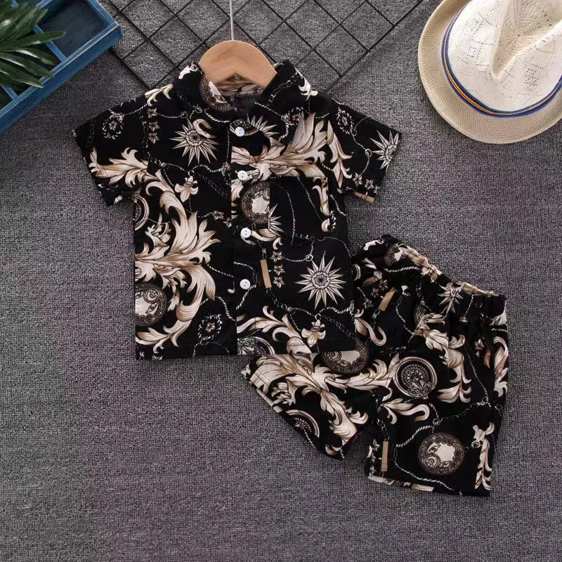Black short-sleeve shirt and matching shorts with cream sun and scroll motifs