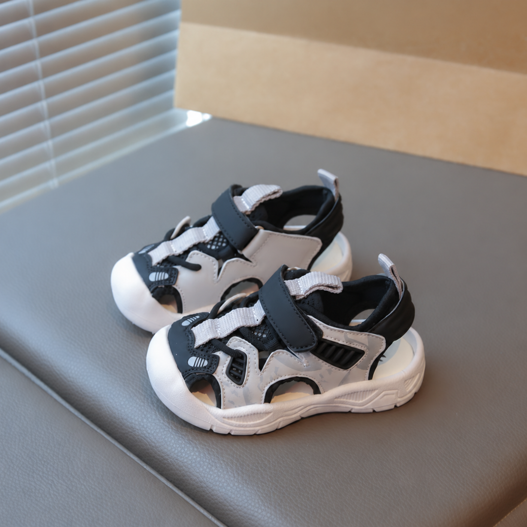Black and cream closed-toe sandals with top straps and white soles