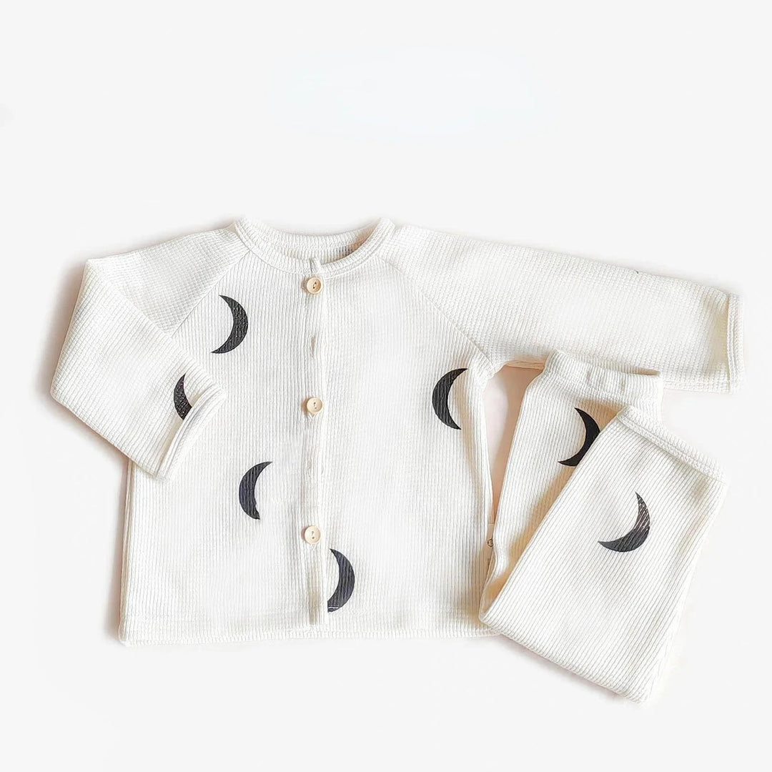 White pajama top and matching pants printed with black crescent moons